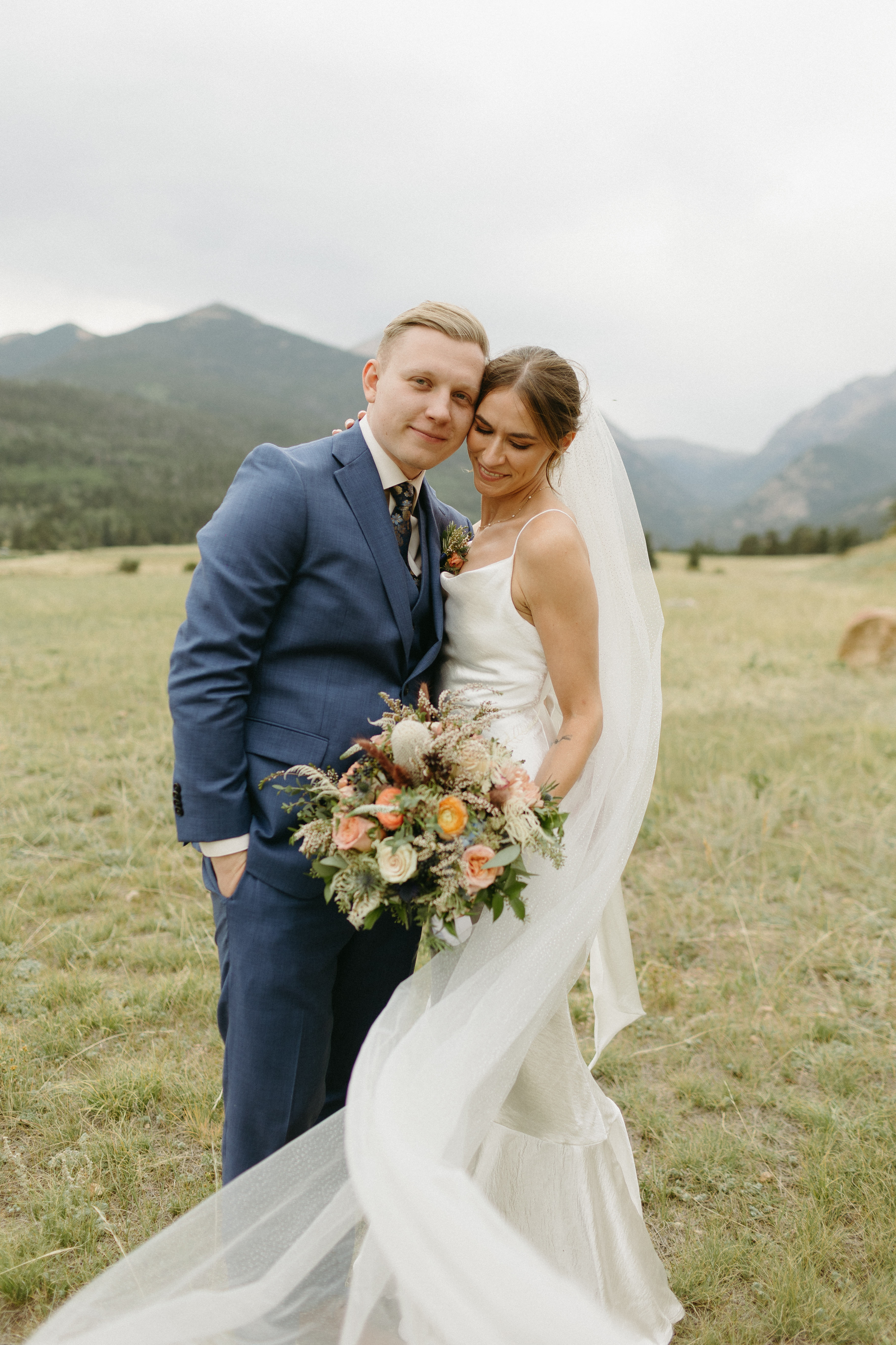 Bride and groom pose during their estes park wedding in colorado